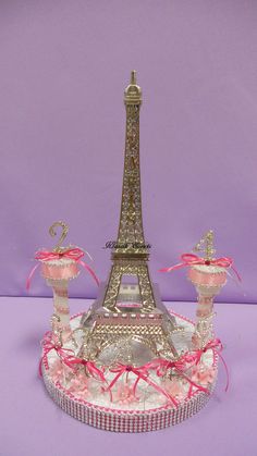 the eiffel tower is decorated with pink ribbons and bows on it's base