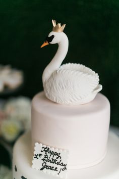 a white cake with a swan on top and a happy birthday message written on it