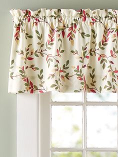 a window with a flowered valance hanging from it's side