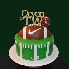 a cake with a football on top and the number two is decorated like a football