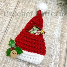 a red and white knitted christmas hat with candy bar