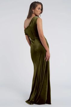 a woman in a long green dress with one shoulder open and her back to the camera