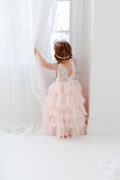 This dress is just beautiful! It includes a delicate white lace bodice with tiered blush pink tutu skirt. It also has an embellished sash on the front that is not removable. The V Back with unfinished lace adds the perfect amount of boho chic look to this amazing Tea length dress. Perfect for your next special event. Nicolette's Couture is a family owned boutique based out of Dubuque, Iowa. When creating looks, comfort is our main priority...regardless of how chic a style is. We've had amazing s Blush Flower Girl Dresses, Pink Tutu Skirt, Dress Blush Pink, Dubuque Iowa, Lace Flower Girl Dress, Pink Flower Girl Dresses, White Lace Wedding Dress, Tulle Wedding Gown, Boho Beach Wedding