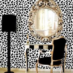 a leopard print wallpaper with a mirror and chair