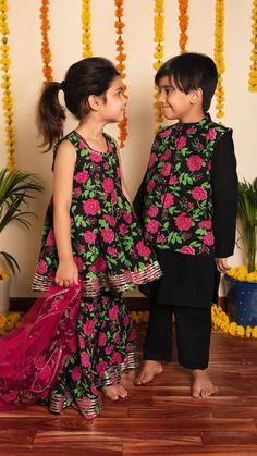 Make kids childhood memorable with this elegant 3 piece kurta-pant set with nehru jacket This set comes with solid black rayon kurta with round neck, full sleeves teamed with solid rayon pants and cotton sleeveless printed nehru jacket with collared neck. 3 piece Suit Set Fabric-Rayon Jacket Fabric-Cotton Color-Black, pink & green Work-Solid with floral printed jacket Neck-Collared Neck Sleeves-Full Sleeves Kurta with Sleeveless Nehru Jacket Slits-Side Slits Length-Calf Length Care-Easy Wash Siz Kids Ethnic Wear, Kurta Cotton, Bro Sis, Kids Dress Wear, Kurta Neck Design, Girls Frock Design