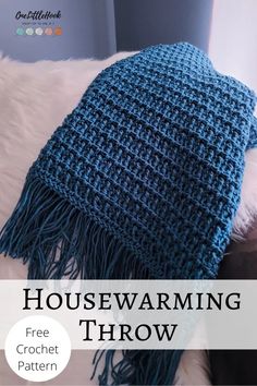 a blue and white blanket with text that reads housewarming throw