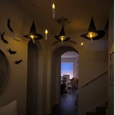 the hallway is decorated with halloween decorations and bats hanging from the ceiling, along with candles