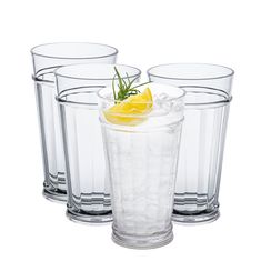 three glasses with lemon and rosemary garnish on the rims, one filled with ice