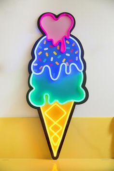 a neon ice cream cone with sprinkles and a heart on the top