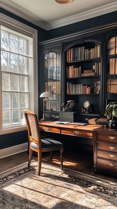 an old fashioned desk in front of a large window