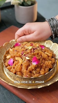 a person is holding a plate with food on it that has pink flowers and petals