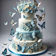 a three tiered cake with blue flowers and butterflies flying around it on a gray background