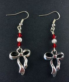 "Antique Silver Ribbon and Bow Earrings with Red and Clear Swarovski Crystals, Festive Holiday Jewelry, Simple Silver and Red Ribbon Earrings Special Holiday Earrings, perfect for gifts and seasonal jewelry Silver Tone Zinc metal alloy(Cadmium Free) Earring Size: ~1.75\" x 3/4\" All Aspen Tree Jewelry is made and stored in a smoke free environment and comes gift wrapped." Red Jewelry For Christmas Celebration, Red Jewelry For Holiday Party, Nickel Free Red Crystal Earrings For Parties, Red Crystal Metal Party Earrings, Red Jewelry For Holiday Jewelry Making, Holiday Red Adjustable Jewelry, Red Metal Crystal Party Earrings, Red Crystal Metal Earrings For Parties, Red Crystal Drop Earrings For Gifts