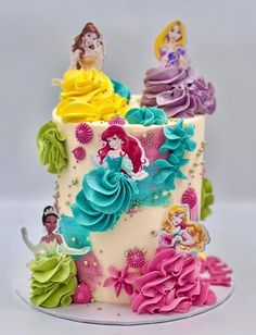 there is a cake decorated with princesses on it