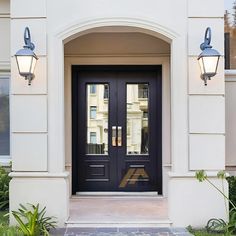 a black front door with two lights on each side