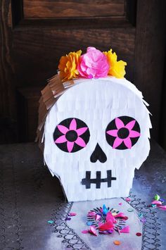 a paper skull with flowers on its head