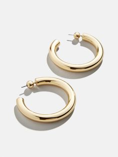 The perfect chunky gold hoops are just a click away. Our Dalilah Earrings are a must-have jewelry essential for your arsenal. Thick tubes of metal are crafted in a timeless hoop shape and topped off with a comfortable post-back closure. Lightweight and easy to layer (if you so choose), you're bound to reach for these staples again and again. Jewelry Essentials, Again And Again, Gold Hoops, Bracelet Sizes, Custom Items, Arsenal, Gold Plate, Collage, Gold