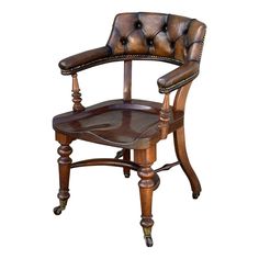 an old fashioned chair with leather upholstered seat