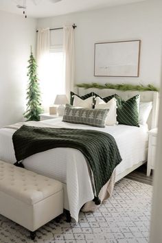 a bedroom with white walls and green accents