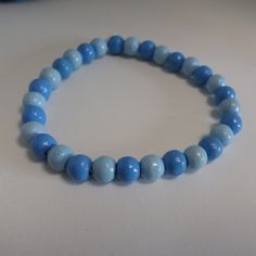 A blue Bracelet with Wooden beads The wood beads are threaded on an eco elastic band. (made out of cotton and natural rubber) Colours: Beads: light blue, middle blue Elastic band: white Colour and shape of the beads may vary since these beads are natural materials Size: Please measure the breadth of your wrist in cm . When in doubt, pick 1cm more to make sure it's comfortable. Size of the beads: ca 6mm Handmade in Germany The Pictures are examples, since every product is made by hand there are n Cheap Light Blue Round Beads Bracelets, Adjustable Blue Beaded Bracelets With Wooden Beads, Blue Wooden Beaded Bracelets For Beach, Blue Wooden Beads Bracelet, Light Blue Beaded Bracelets With Round Beads, Casual Blue Beaded Bracelet With Large Beads, Casual Blue Bracelets With Large Beads, Casual Light Blue Round Bead Jewelry, Casual Light Blue Beaded Bracelets