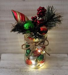 a mason jar filled with ornaments and lights