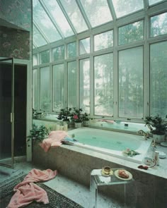 a bathroom with a large bathtub next to a walk in shower