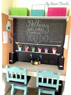 two children's desks with chalkboard on the wall and chairs in front