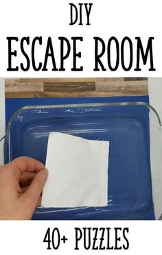 the diy escape room has four pieces of white paper on it and is being held up