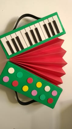 an accordion made to look like a piano keyboard with polka dots on the top and bottom