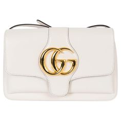 100% authentic Gucci Small Arli flap bag in white calfskin featuring gold-tone hardware. The interior is lined in a light pink grosgrain fabric and divided in two compartments with one zipper pocket against the back. Has been carried and shows some scratches on the flap, under the flap and around the magnetic button. Comes with dust bag. Measurements Model 550129 498879 Height 14cm (5.5in) Width 25cm (9.8in) Depth 2cm (0.8in) Shoulder Strap Length 120cm (46.8in) Hardware Gold-Tone Blindstamp 550 Bag Measurements, Small Shoulder Bag, Flap Bag, Fashion Handbags, White Leather, Calf Skin, Zipper Pocket, Light Pink, Dust Bag