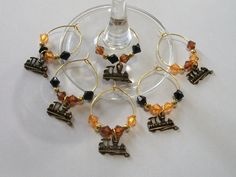 several wine glasses with charms attached to them