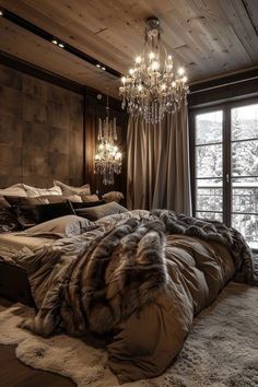 a bedroom with a large bed, chandelier and wooden walls in the background