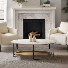 a living room with two chairs and a fireplace in the corner that is decorated with greenery