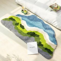 there is a rug on the floor with green and blue designs