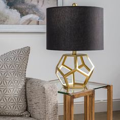 a table with a lamp on it next to a couch