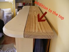 a wooden table with a red arrow pointing to the top