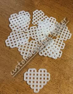 several pieces of white plastic sitting on top of a wooden table