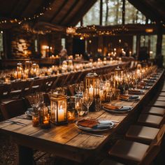 a long table with candles and plates on it