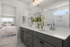 a bathroom with two sinks and a large mirror