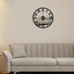 a living room with a couch and clock on the wall