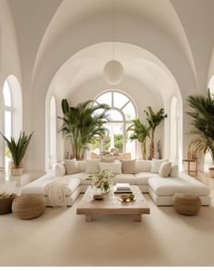 a living room filled with lots of white furniture