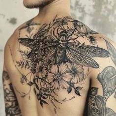 a man with tattoos on his chest and back