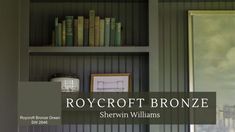 there is a book shelf with books on it and the words roycroft bronze