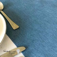 two forks and spoons on a blue place mat