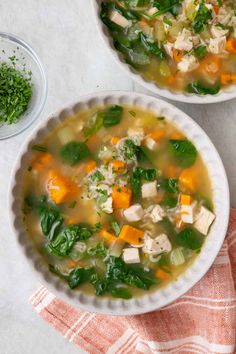 two bowls filled with chicken and vegetable soup