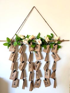 a bunch of tags hanging on a wall with flowers and numbers attached to them,