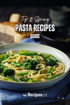 a white bowl filled with pasta and broccoli on top of a blue towel