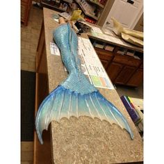 a glass mermaid tail sitting on top of a counter