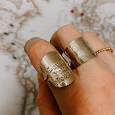 Hand stamped ring with words or symbols of your choosing (from our available options) creates a molded coin shield on the top and a dainty ring band beneath. To order your custom ring, leave an order note at check out with what you would like stamped, or email to shop@derivejewelry.com prior to your order to arrange your custom ring today! All custom stamped pieces are final sale. Available in 14k gold fill or Sterling Silver. Sand Dollar Necklace, Stamped Ring, Hand Stamped Ring, Garnet Heart, Shield Ring, Stamped Rings, Rainbow Necklace, Custom Ring, Moonstone Earrings