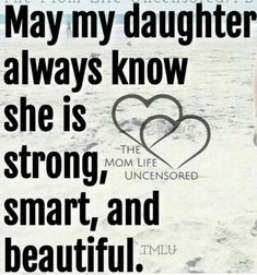 a woman standing on top of a sandy beach next to a heart shaped sign that reads, may my daughter always know she is strong, strong, smart, and beautiful